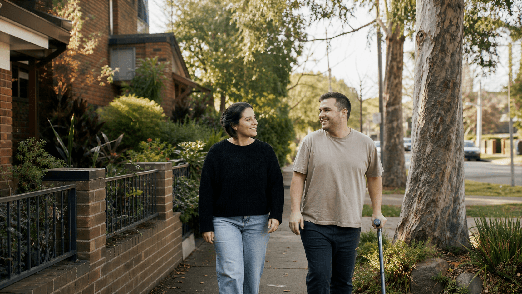 Support worker walking with a participant through a Melbourne neighbourhood